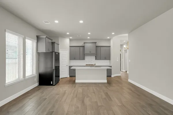 a view of kitchen with stainless steel appliances refrigerator microwave and stove