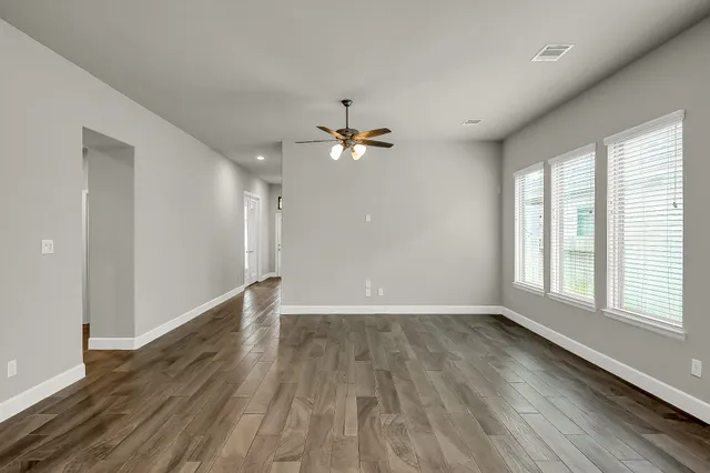 wooden floor in an empty room with a window