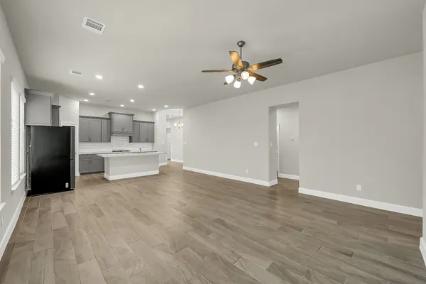 a view of a kitchen with a sink dishwasher a refrigerator with wooden cabinets
