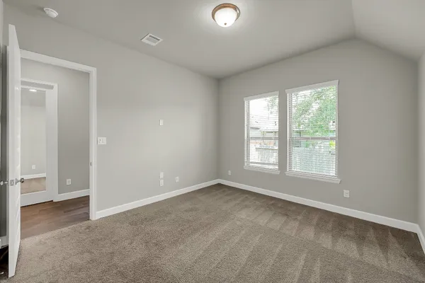 an empty room with windows and closet