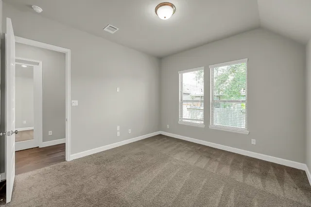 an empty room with windows and closet