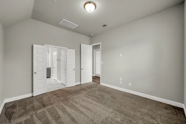 a view of a livingroom with wooden floor and bathroom