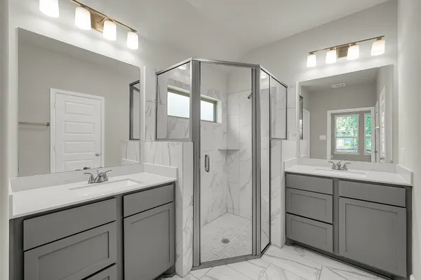 a bathroom with a shower sink and mirror