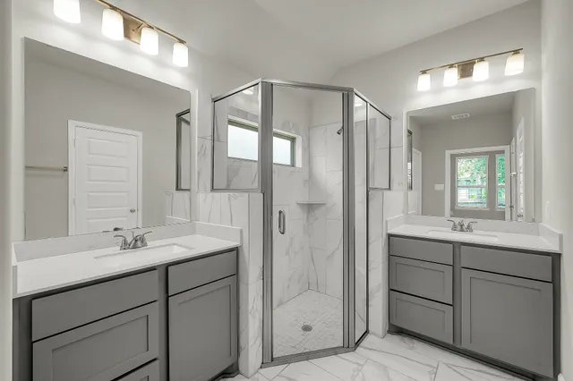 a bathroom with a shower sink and mirror
