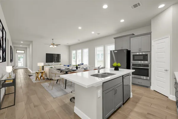 a open kitchen with stainless steel appliances kitchen island granite countertop a sink and cabinets