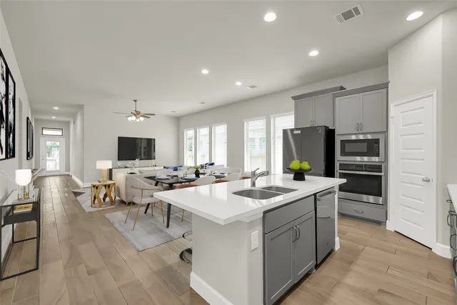 a open kitchen with stainless steel appliances kitchen island granite countertop a sink and cabinets