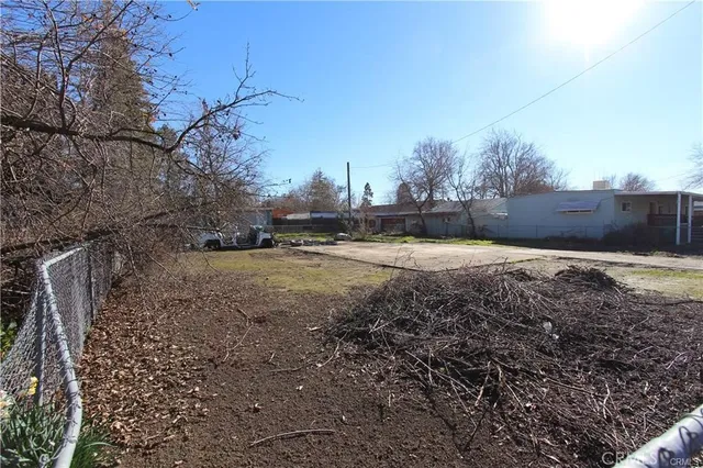 a view of a yard with wooden fence