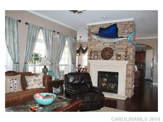 573 Quicksilver Trail Fort Mill, SC 29708 - Photo 2 of 16 a living room with furniture a fireplace and a large window
