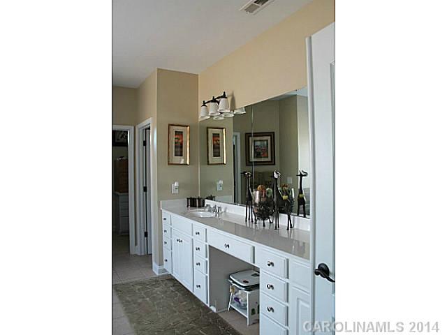 573 Quicksilver Trail Fort Mill, SC 29708 - Photo 11 of 16 a spacious bathroom with a double vanity sink and a mirror
