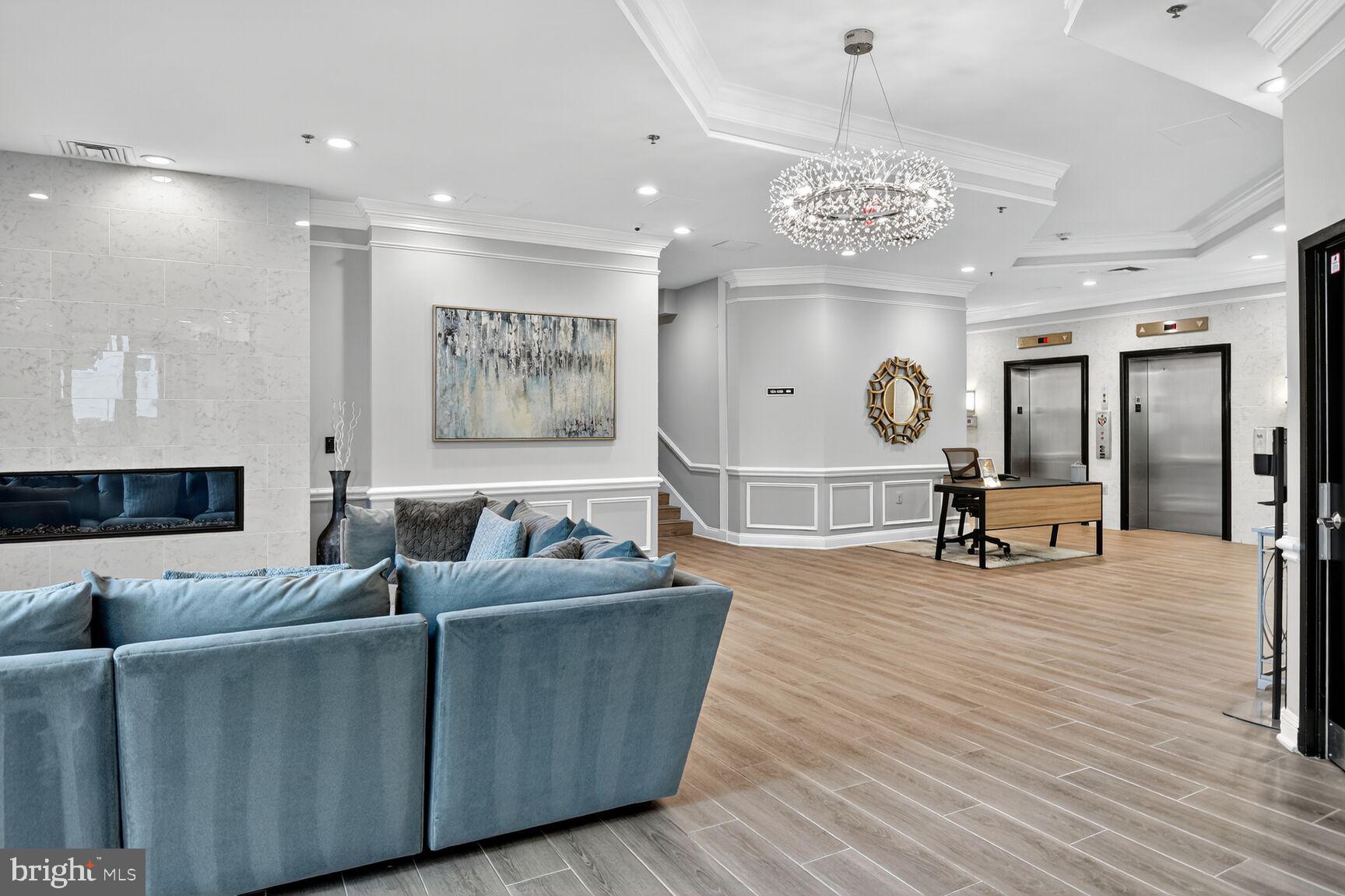 1001 North Vermont Street, Unit 102 Arlington, VA 22201 - Photo 17 of 27 a living room with furniture and a chandelier