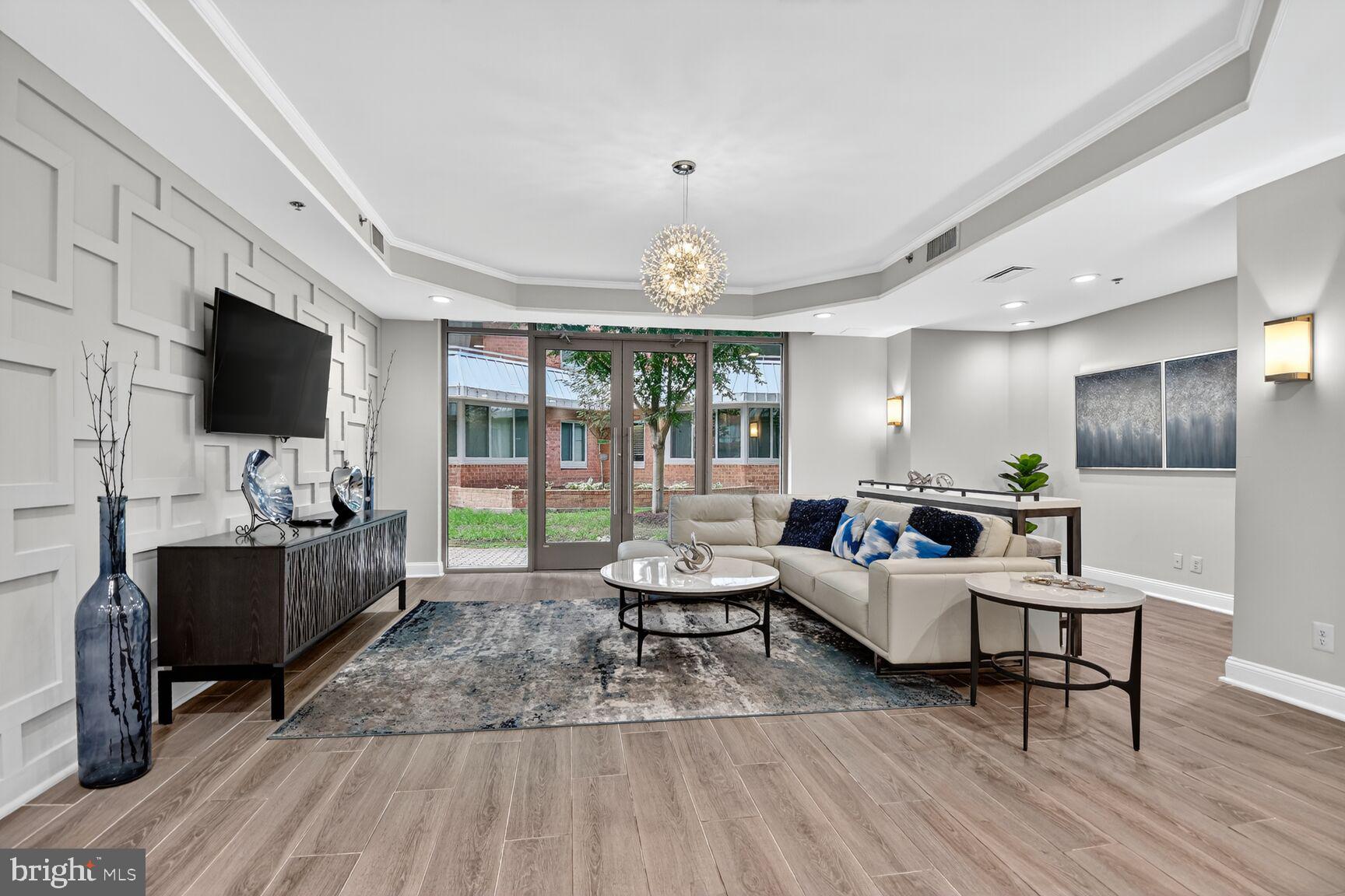 1001 North Vermont Street, Unit 102 Arlington, VA 22201 - Photo 20 of 27 a living room with furniture a flat screen tv and a fireplace