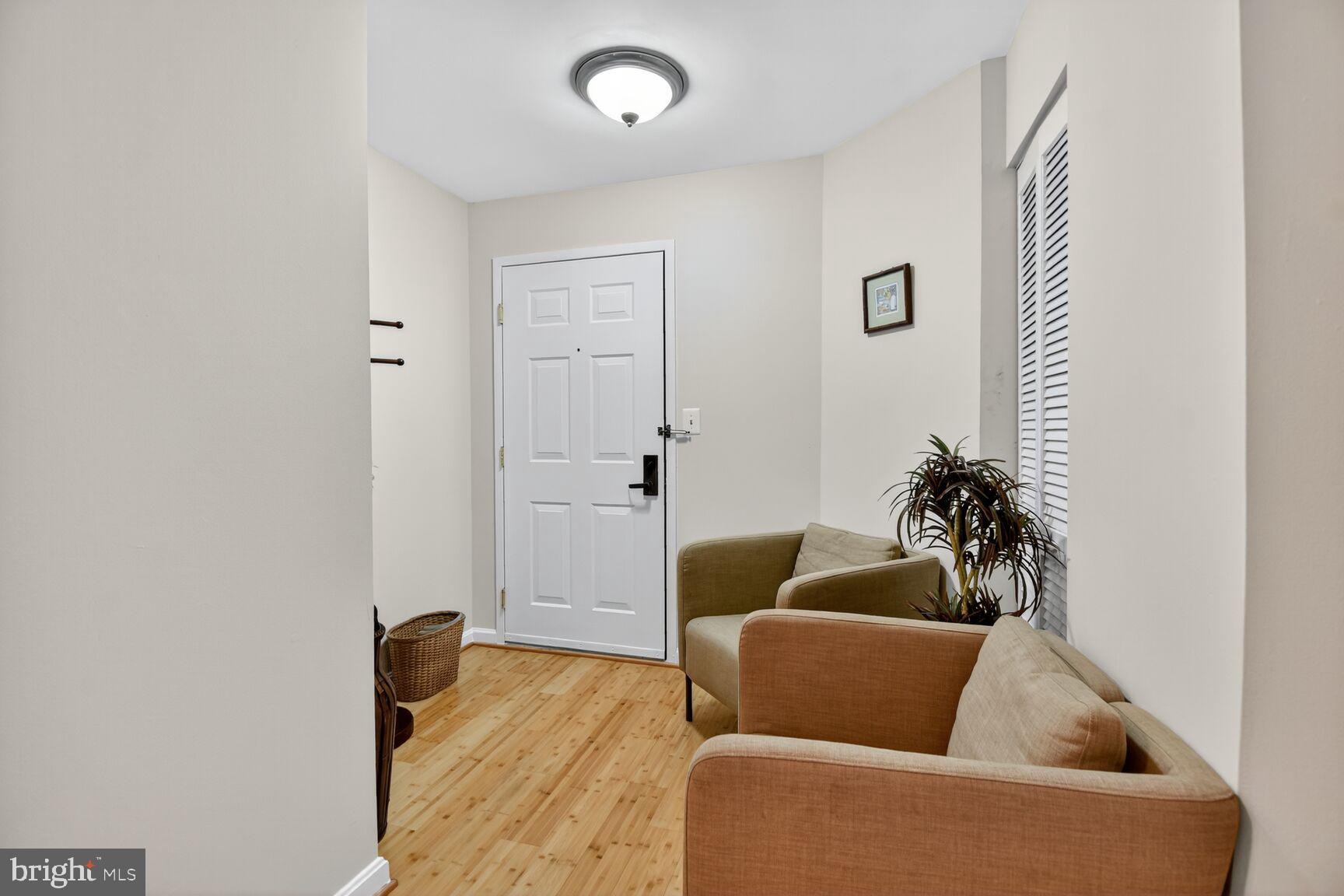 1001 North Vermont Street, Unit 102 Arlington, VA 22201 - Photo 2 of 27 a living room with furniture and a potted plant