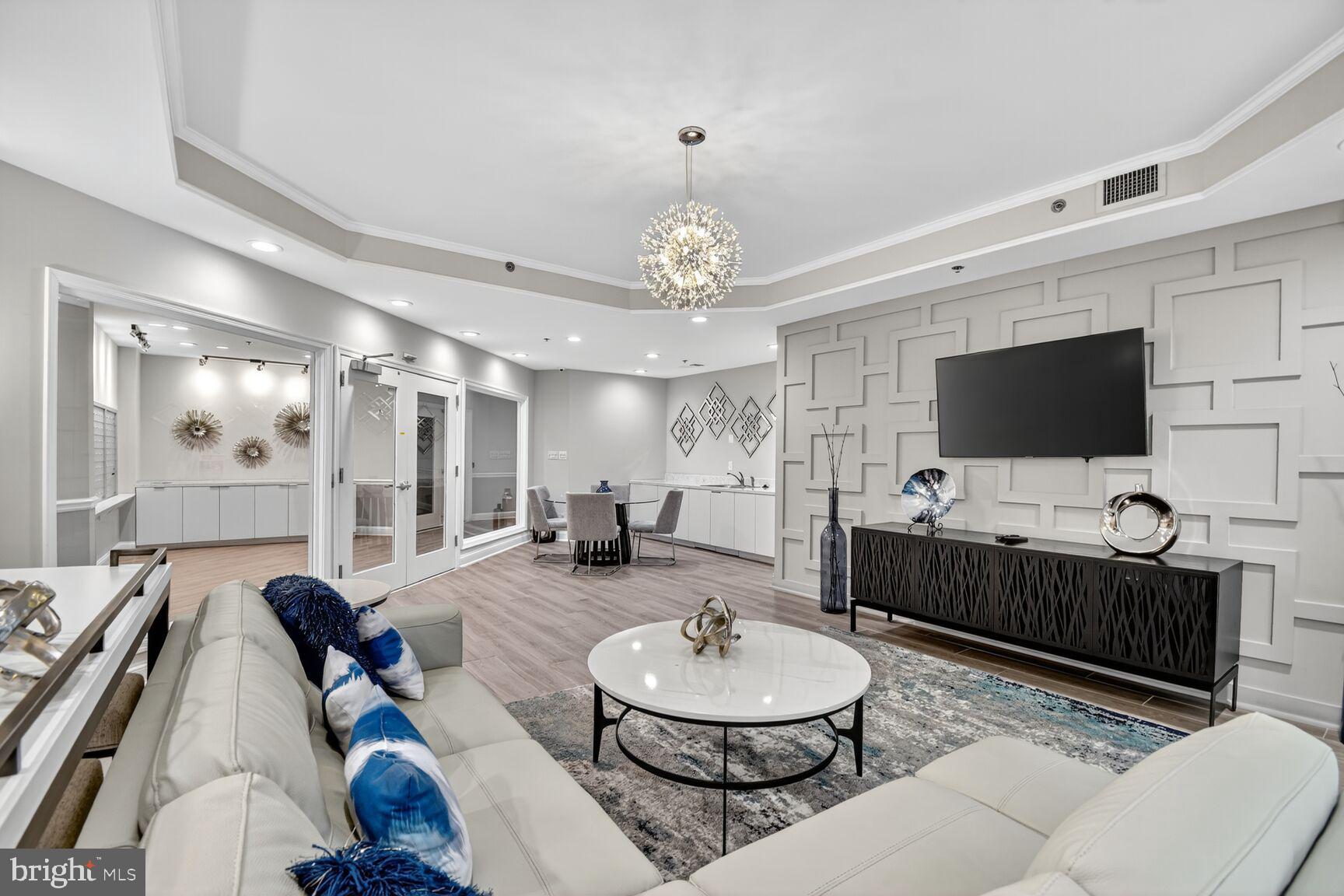 1001 North Vermont Street, Unit 102 Arlington, VA 22201 - Photo 22 of 27 a living room with furniture a flat screen tv and kitchen view
