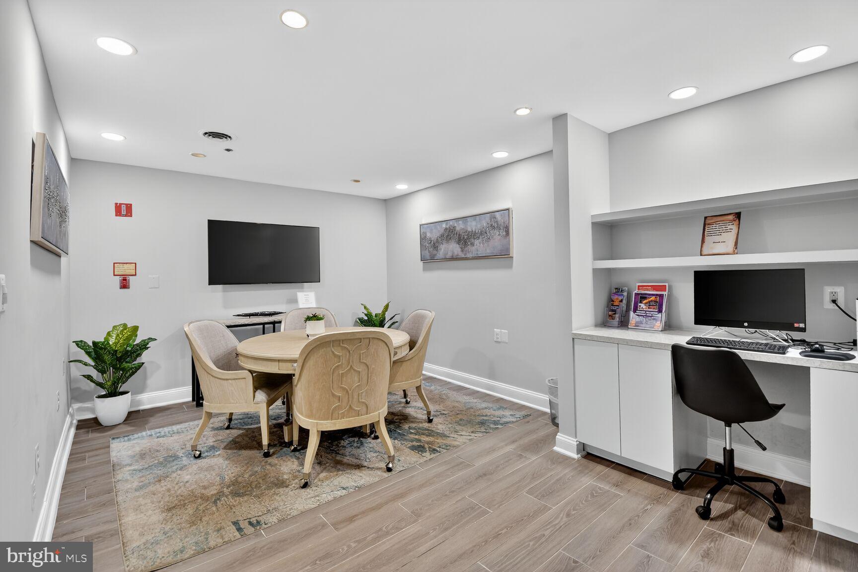 1001 North Vermont Street, Unit 102 Arlington, VA 22201 - Photo 23 of 27 a workspace with furniture and a flat screen tv
