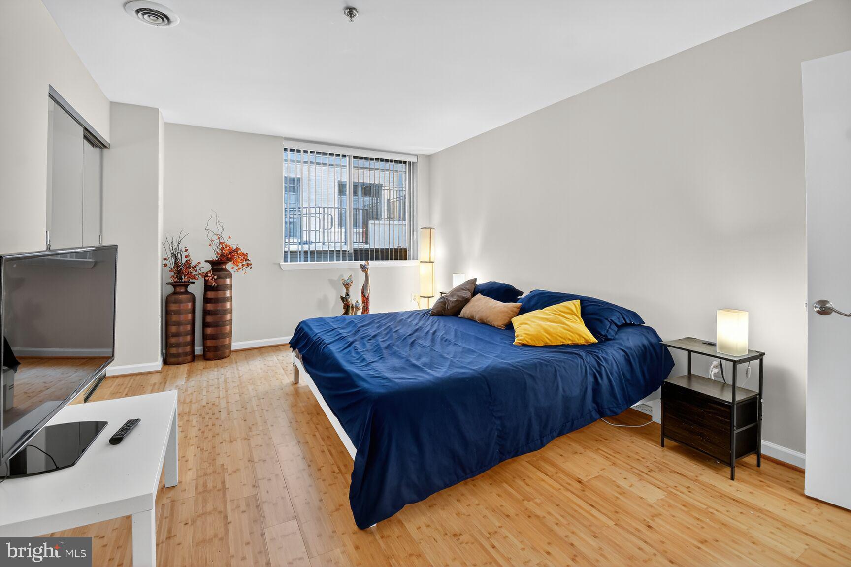 1001 North Vermont Street, Unit 102 Arlington, VA 22201 - Photo 10 of 27 a bedroom with a bed and a flat screen tv