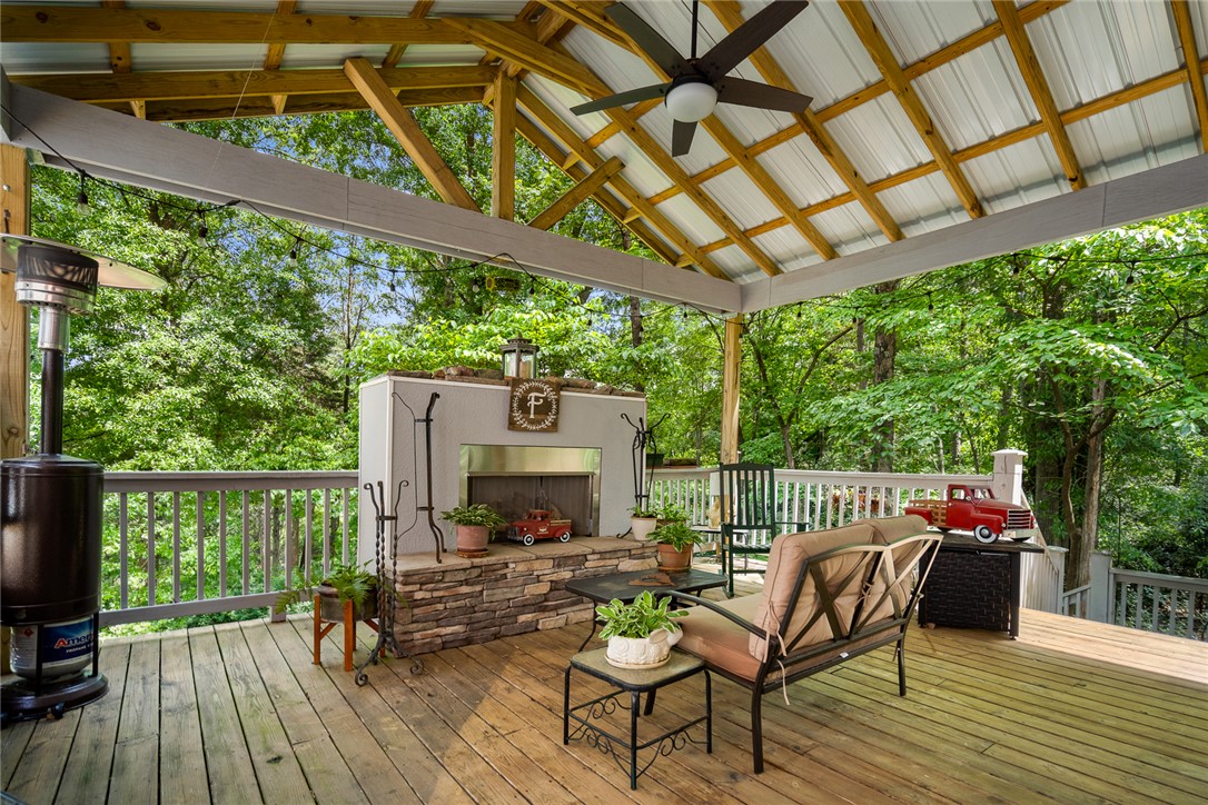 324 Hobson Road Anderson, SC 29621 - Photo 34 of 46 An inviting covered patio offers a stone fireplace and treetop views.