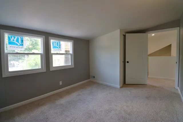 a bathroom with a sink a toilet and a window