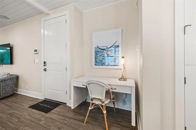 a view of a workspace with furniture and wooden floor