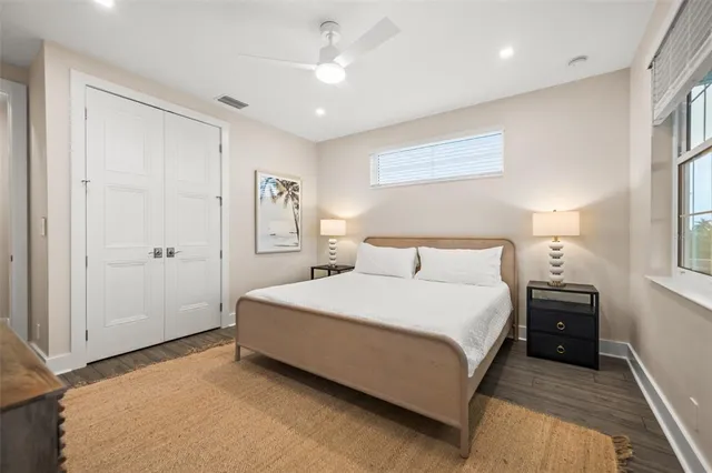 a spacious bedroom with a bed and a chandelier