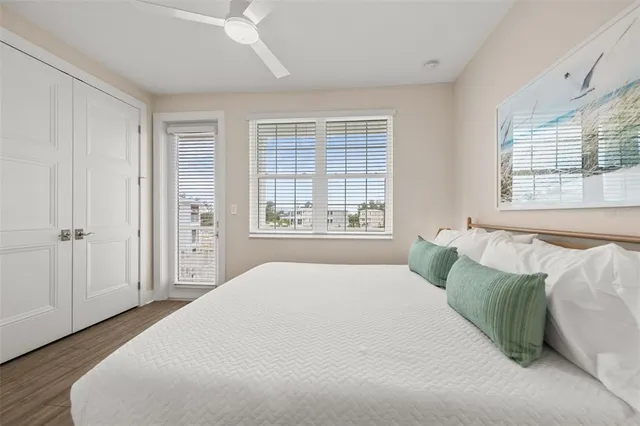 a large bed sitting in a bedroom next to a window with a dresser