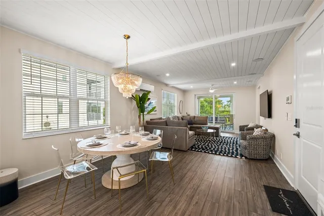 a living room with furniture a window and wooden floor