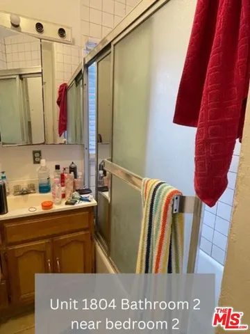 a bathroom with a sink a mirror and a bathtub