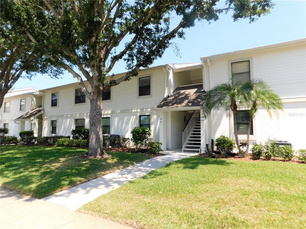 107 Windward Place, Unit 107 Oldsmar, FL 34677 - Photo 1 of 34 a front view of a house with a yard