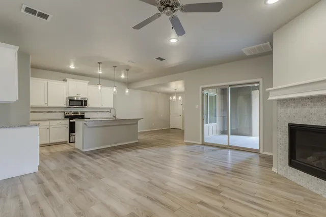 a large kitchen with kitchen island a sink stainless steel appliances and cabinets