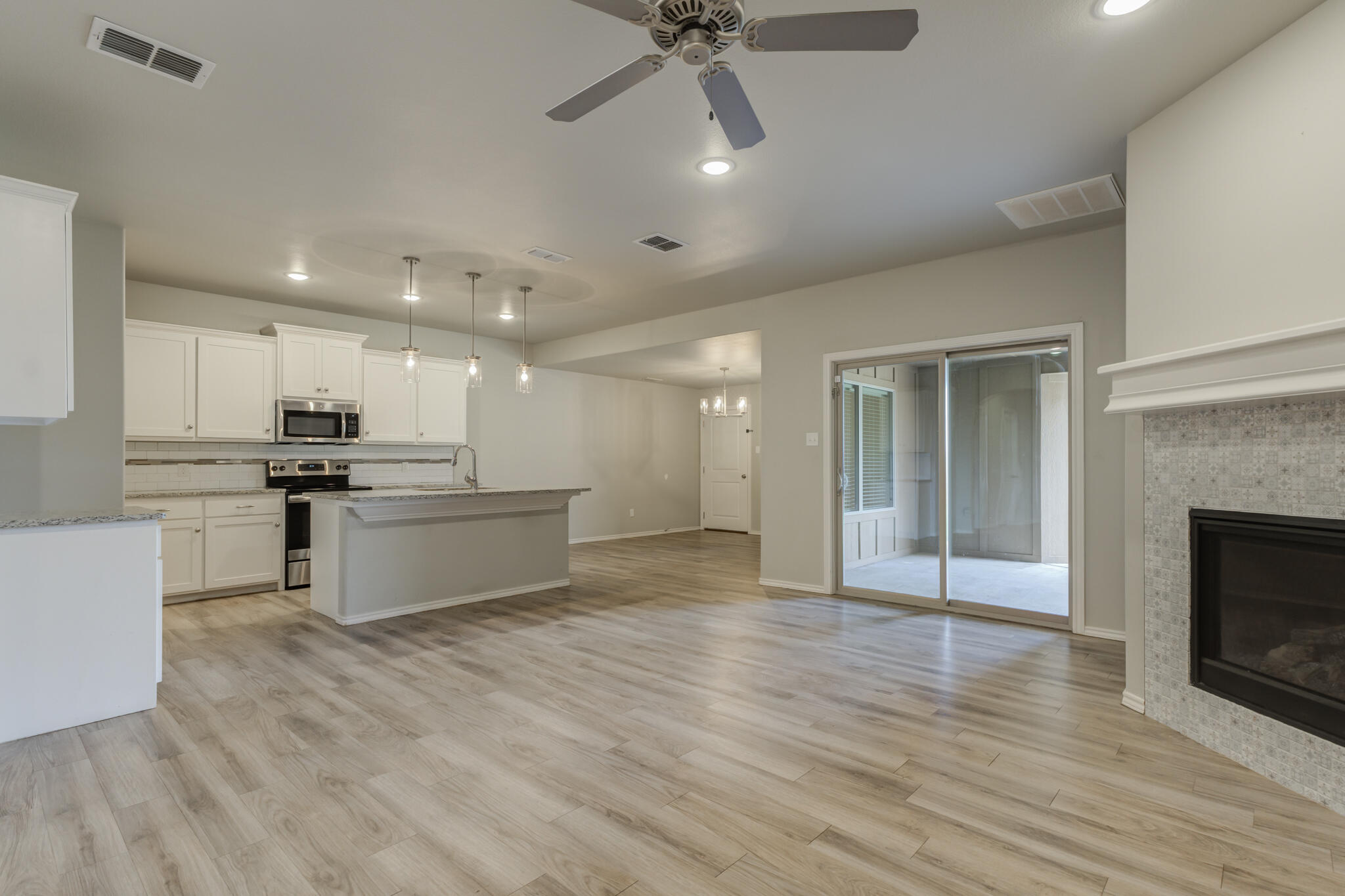 6902 67th Street Lubbock, TX 79424 - Photo 2 of 35 a large kitchen with kitchen island a sink stainless steel appliances and cabinets