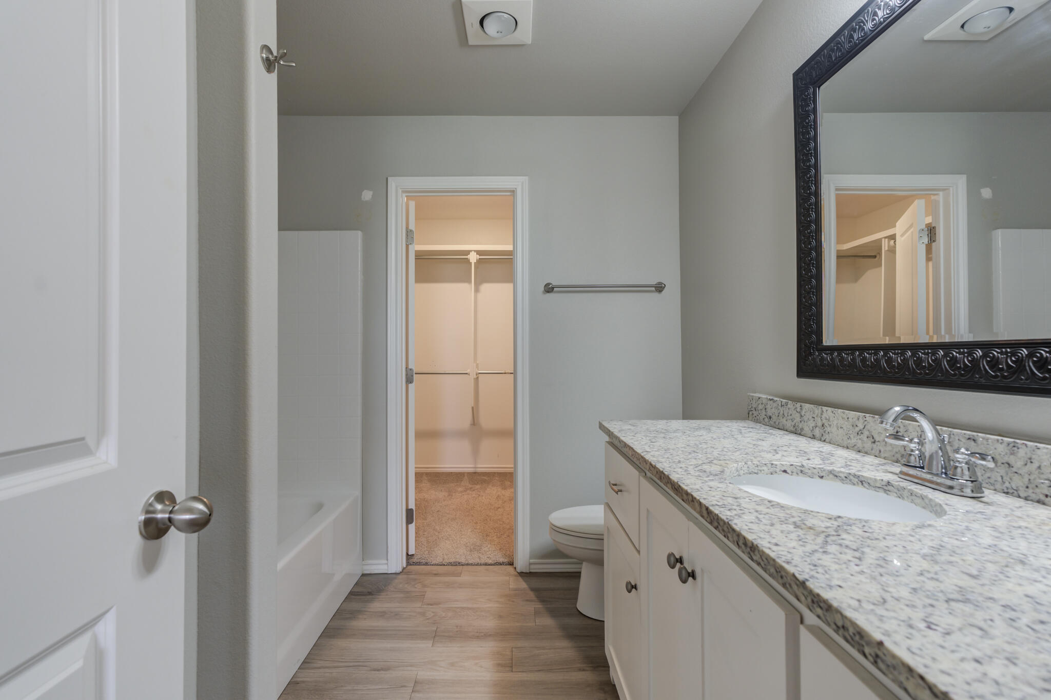 6902 67th Street Lubbock, TX 79424 - Photo 22 of 35 a bathroom with a granite countertop sink and a mirror