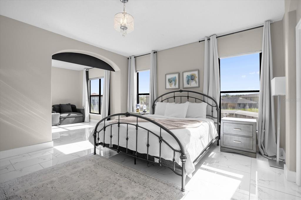 9657 Moss Rose Way Orlando, FL 32832 - Photo 14 of 33 a bedroom with a bed and a mirror