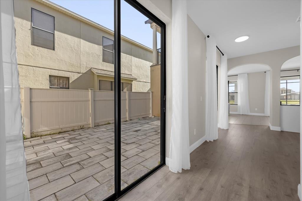 9657 Moss Rose Way Orlando, FL 32832 - Photo 27 of 33 a view of a hallway with wooden floor and staircase