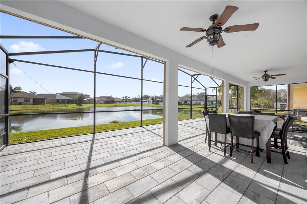 9657 Moss Rose Way Orlando, FL 32832 - Photo 31 of 33 a dining room with furniture and a floor to ceiling window