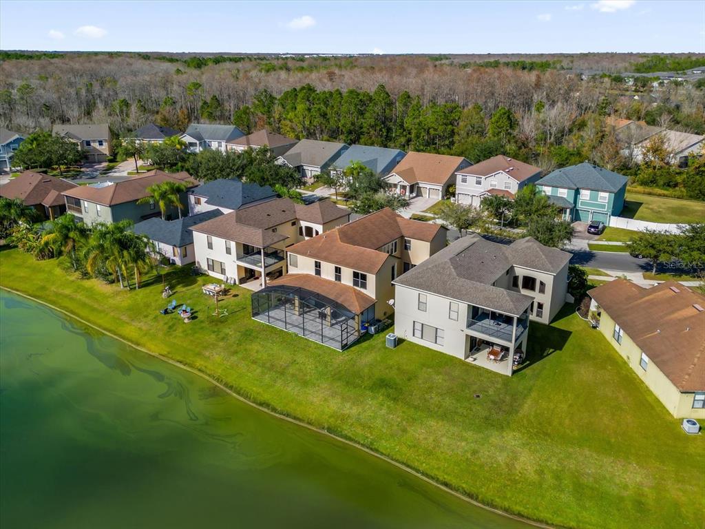 9657 Moss Rose Way Orlando, FL 32832 - Photo 33 of 33 an aerial view of a house with swimming pool and mountains