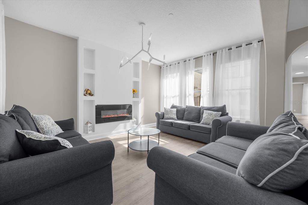 9657 Moss Rose Way Orlando, FL 32832 - Photo 5 of 33 a living room with furniture and a fireplace