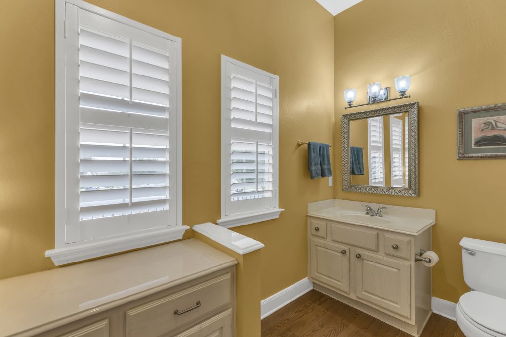 144 Cattle Trail Way Georgetown, TX 78633 - Photo 22 of 37 A well-appointed bathroom features hardwood flooring and bright window shutters.