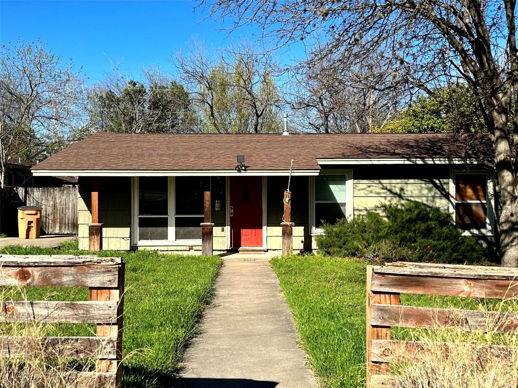 a front view of a house with a yard table and chairs