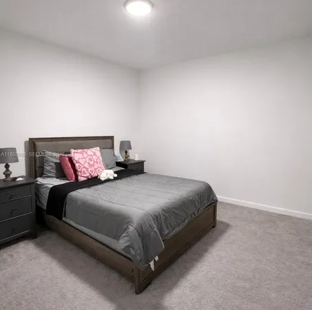 a bedroom with a bed and a table
