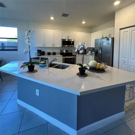 a kitchen with a sink a stove and refrigerator
