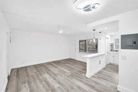 a view of kitchen with microwave and cabinets