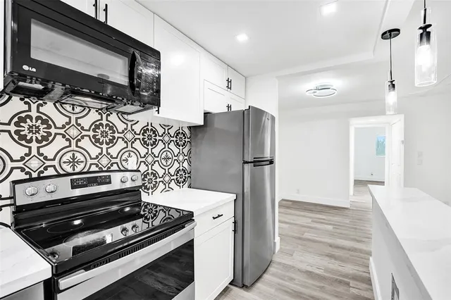a kitchen with wooden cabinets and stainless steel appliances