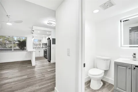 a bathroom with a toilet sink and a mirror