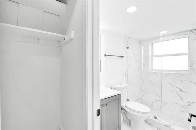 a bathroom with a toilet a sink and a shower