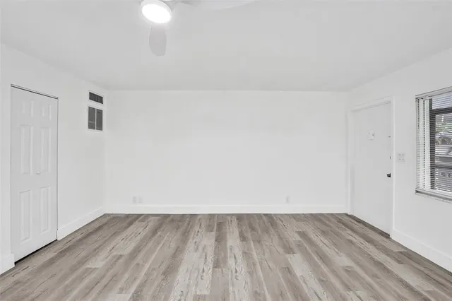 a view of a room with wooden floor