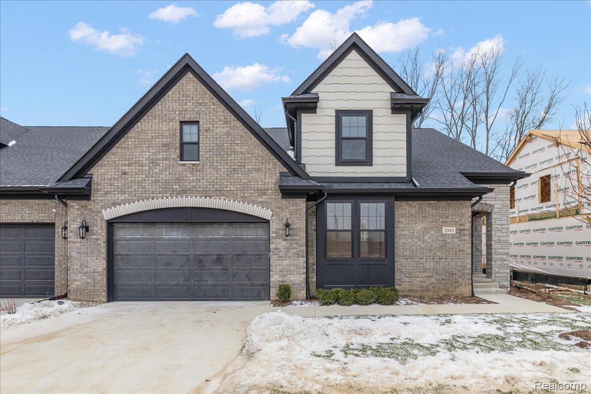 2044 Breckenridge Court Rochester, MI 48309 - Photo 2 of 33 View of front facade featuring brick siding, a garage, concrete driveway, and roof with shingles