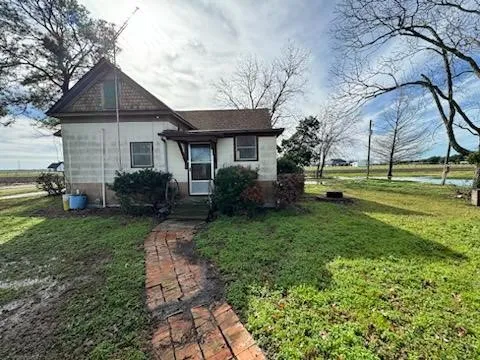a front view of house with a garden