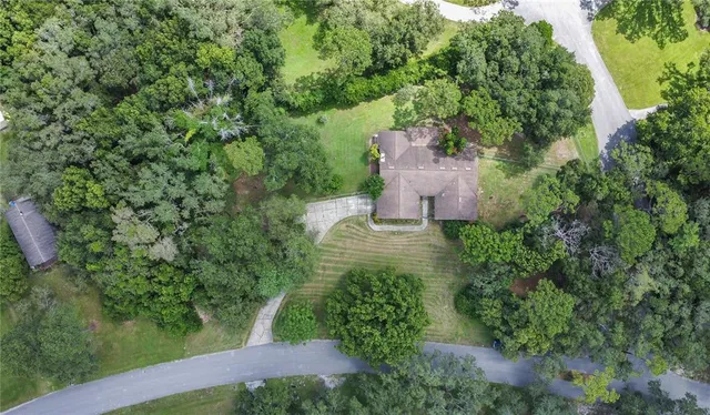 an aerial view of a house with a yard