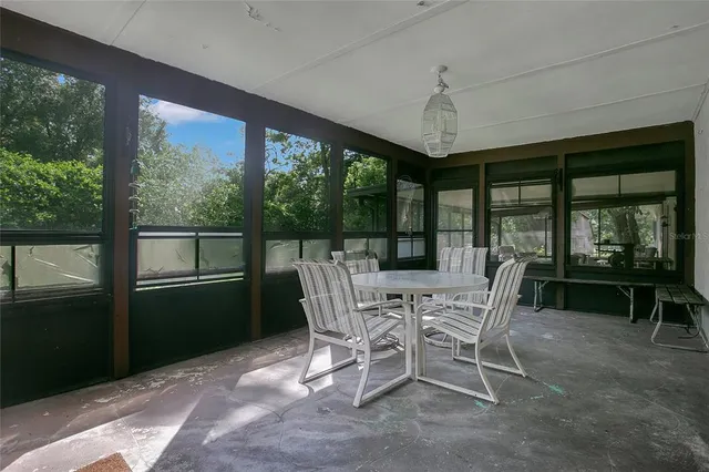 a view of a dining room with furniture large windows and wooden floor