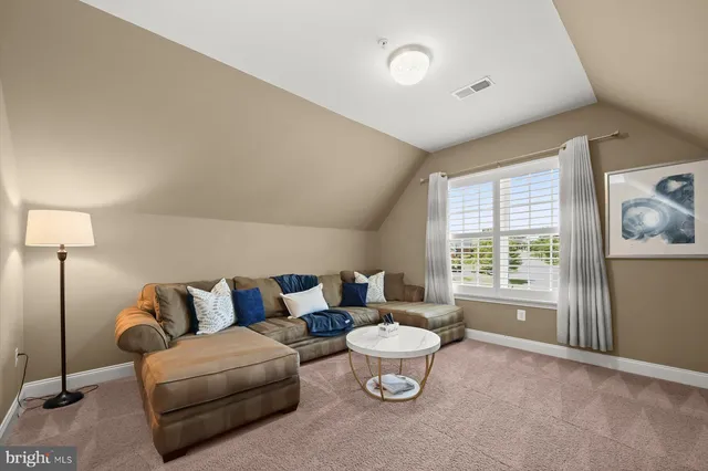 a spacious bedroom with a bed and window