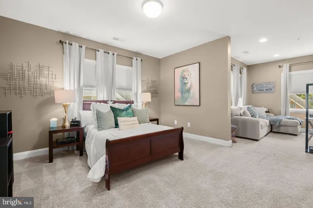 a dining room with furniture and a potted plant